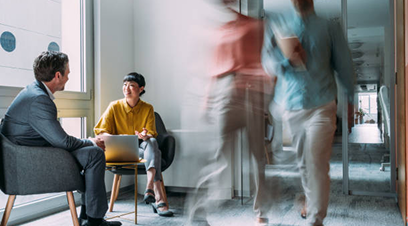 employees talking and walking through office